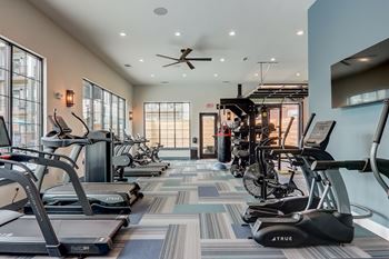 a gym with treadmills and ellipticals